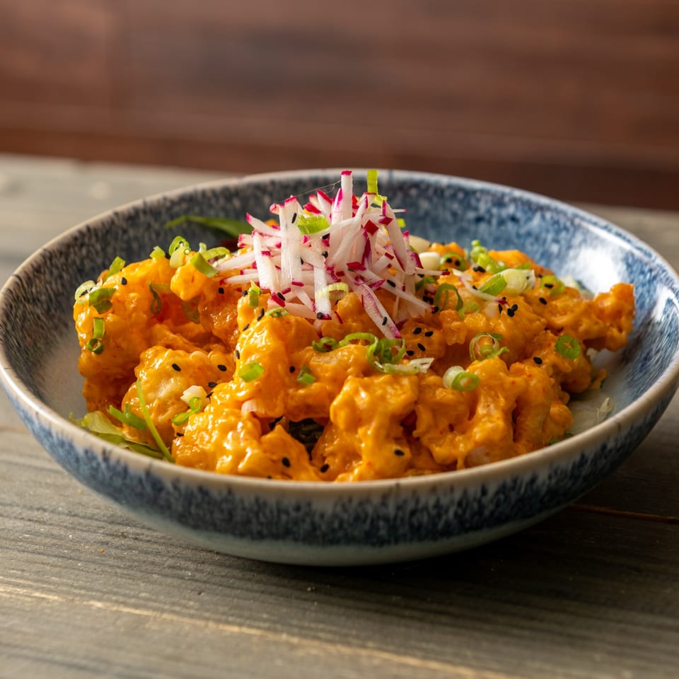 Crispy bites with creamy sauce and fresh garnish