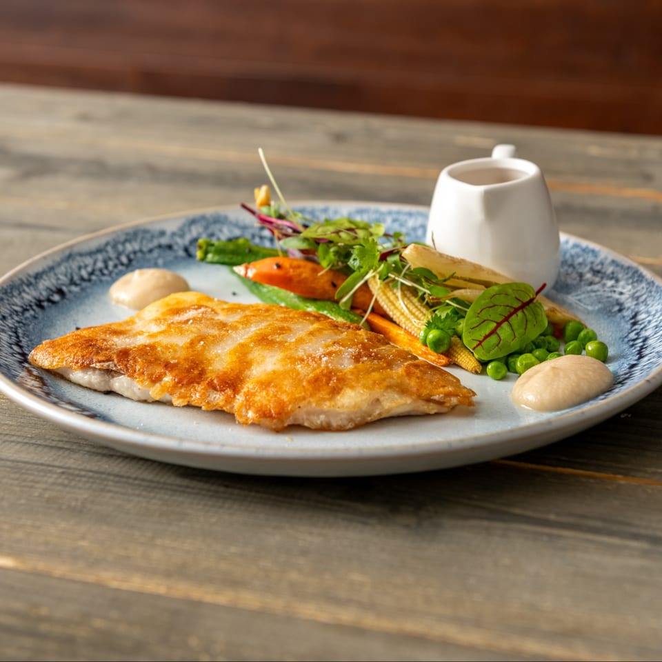 Golden fish fillet with garden vegetables